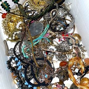 Box of miscellaneous costume jewelry. Box has broken and unbroken pieces.